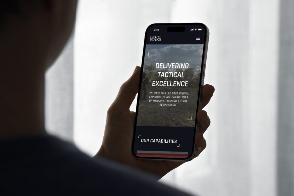 Mockuuups iphone 15 pro mockup in a male hand against soft backlight